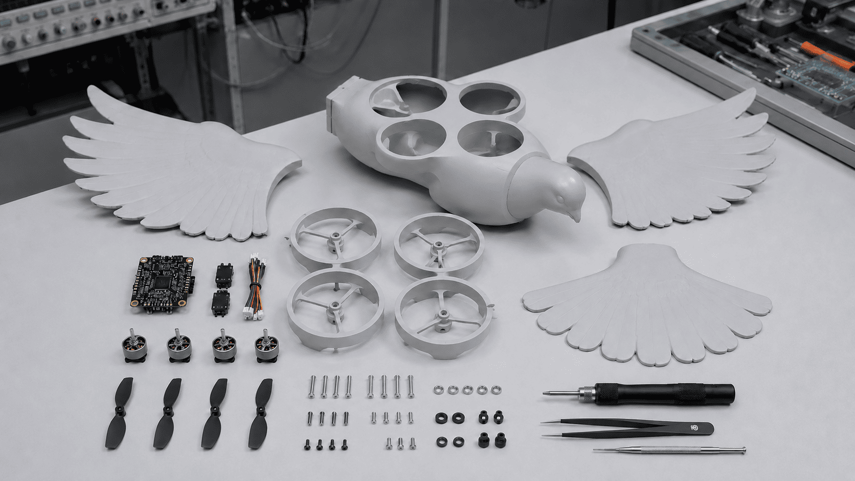 DOVE fuselage, wing elements, motors, propellers and electronics arranged on a workbench